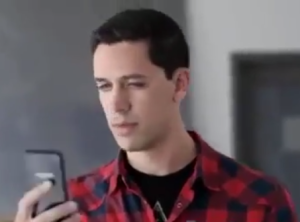 man staring at amazon fire phone in confusion